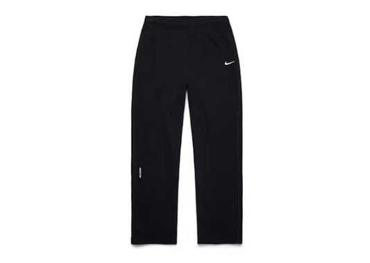 Black Nike NOCTA mens athletic training pants with white swoosh and NOCTA logo.