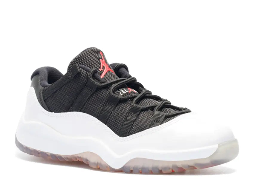 Jordan 11 Retro Low PS White Black True Red sneakers with white patent leather mudguard, black mesh upper.