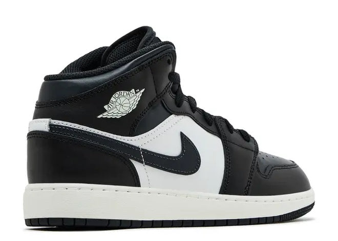 Nike Air Jordan 1 Mid GS Black White sneakers, side view showing Wings logo.