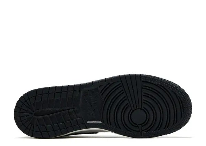 Black outsole of Nike Air Jordan 1 Mid (GS) Black White basketball shoes, showing traction pattern.