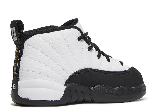 Air Jordan 12 Infants white and black sneaker with gold branding on heel.