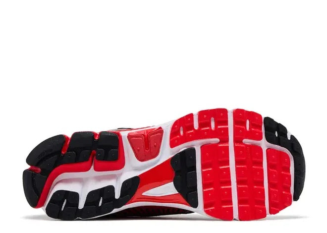 Nike Zoom Vomero 5 running shoe outsole, red, black & white, engineered for comfort & grip.