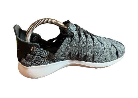Nike Juvenate womens grey woven sneakers with white sole, side view.