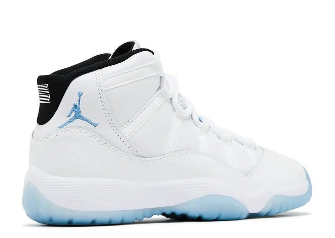 White Air Jordan 11 Boys sneaker with Legend Blue Jumpman, black collar, and icy blue translucent sole.