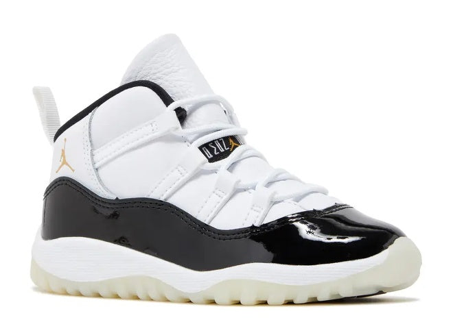 Air Jordan 11 Infants white, black & metallic gold unisex sneaker.