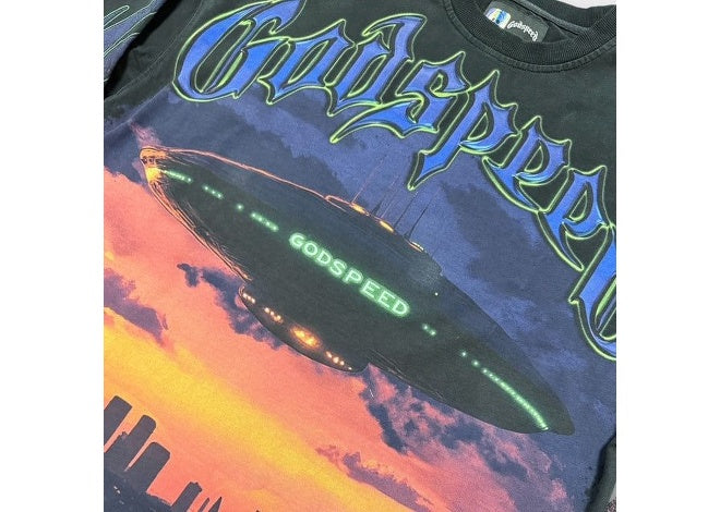 Godspeed U.A.P Black Wash LS graphic tee, glowing blimp over sunset city.