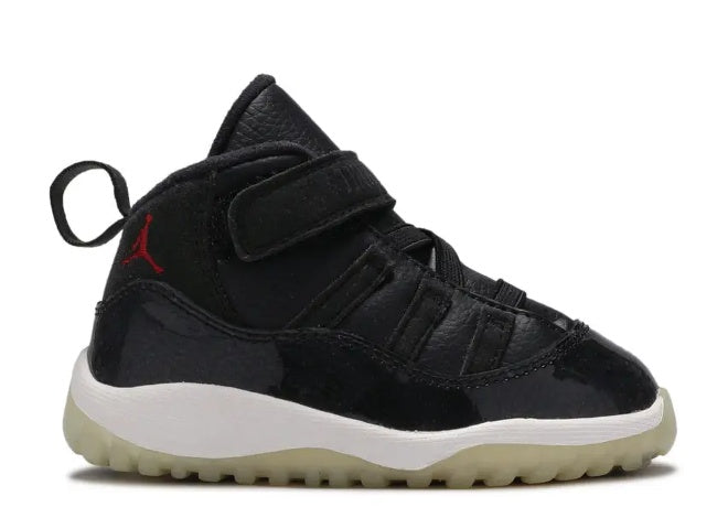 Unisex Air Jordan 11 Infant Black/Gym Red sneaker, white midsole, velcro strap.