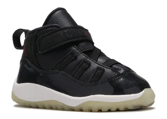 Unisex Air Jordan 11 Infants black gym red sneaker with patent leather and white sole.
