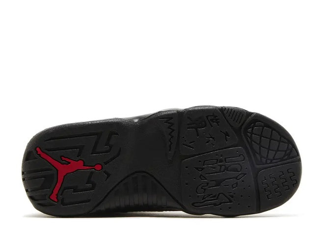 Black Air Jordan 9 Infants sneaker outsole with red Jumpman logo and unique sole patterns.