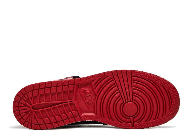 Red outsole of Air Jordan 1 High Kids sneaker with Nike logo.