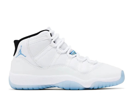 White Air Jordan 11 Kids sneaker with Legend Blue Jumpman logo and translucent blue outsole, black collar.