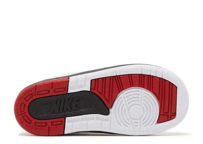 Bottom of Air Jordan 2 TD toddler sneaker: white, varsity red, black, Nike logo.