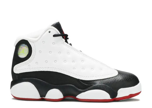 Air Jordan 13 PS kids sneaker in white, black, and red, side profile view.