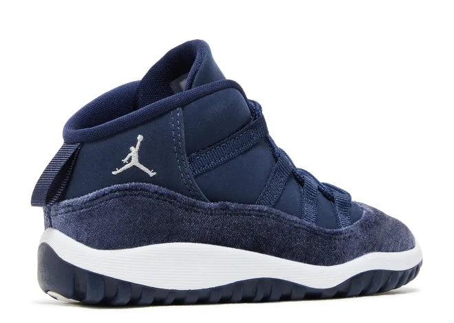 Air Jordan 11 TD Midnight Navy sneaker, metallic silver Jumpman logo, white midsole, side view.