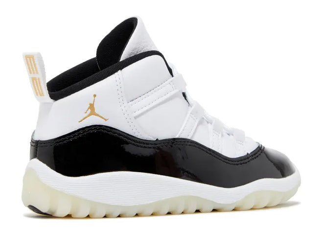 Infant Air Jordan 11 Retro sneaker, white, black patent leather, and gold Jumpman/heel pull.